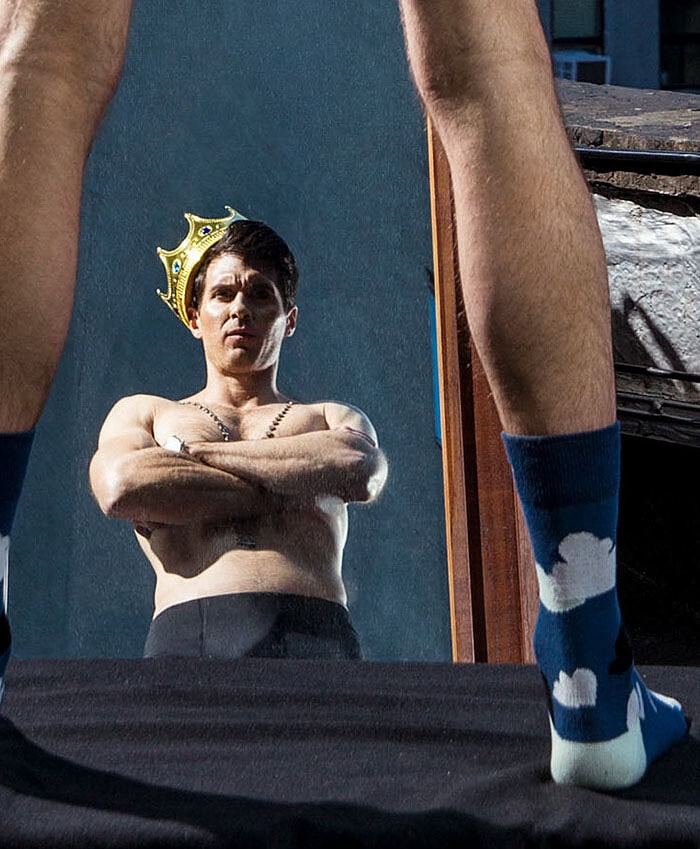 Fashion photo inspired by fairy tales with a woman wearing a crown and socks.